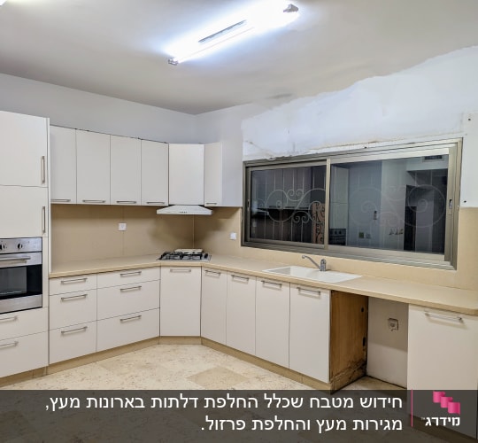 מטבח עם ארונות לבנים, כיור ותנור בילט אין